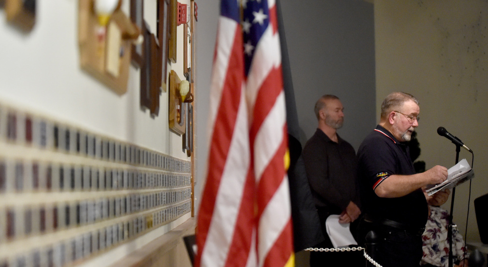 Ken Eaton reads the names of local men killed in the Japanese attack on Pearl Harbor during a remembrance ceremony Wednesday at the Waterville Elks lodge.