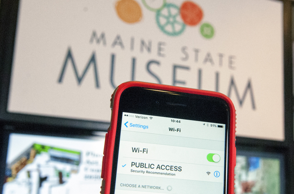 A smartphone's detection of a new Public Access Wi-Fi network is seen in front of a new display Thursday at the Maine State Museum in Augusta.