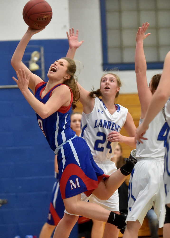 Messalonskee guard Sophie Holmes splits two Lawrence defenders  during a Kennebec Valley Athletic Conference Class A game last season in Fairfield.