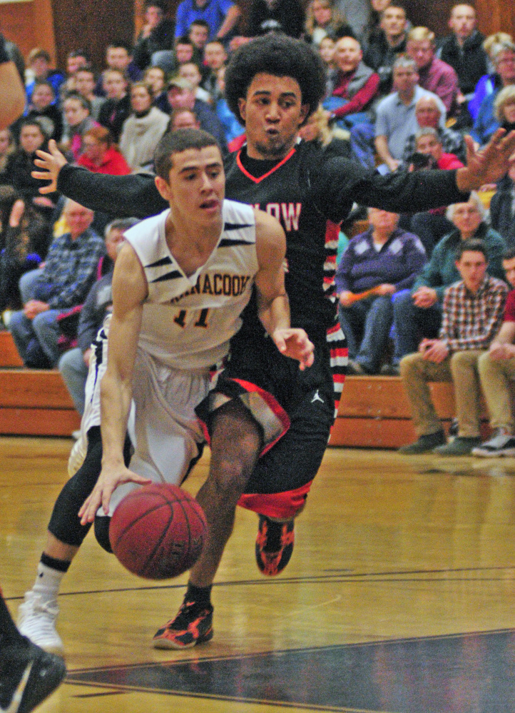 Maranacook guard Kyle Wilbur, left, tries to get around Winslow defender Keanu Earle during a game last Jan. 15 in Readfield. Wilbur and Earle return to the Black Bears and Black Raiders, respectively, this season.