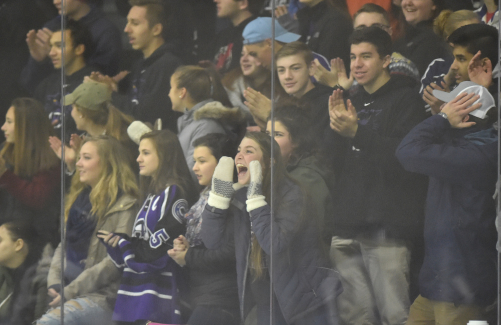 Waterville Senior High School fans celebrate the Purple Panthers' second goal against Hampden Academy at Colby College in Waterville on Saturday night.