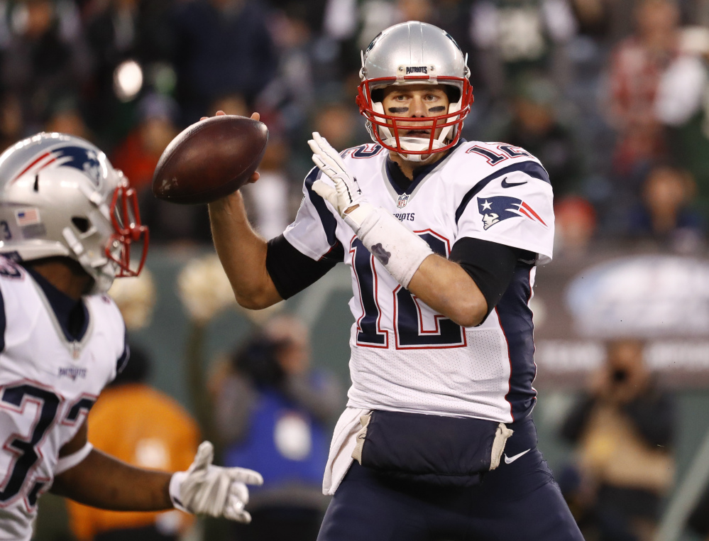New England Patriots quarterback Tom Brady (12) looks to pass to running back Dion Lewis (33) during the first quarter of game game last month in East Rutherford, New Jersey. New England (10-2) hosts the Baltimore Ravens tonight.