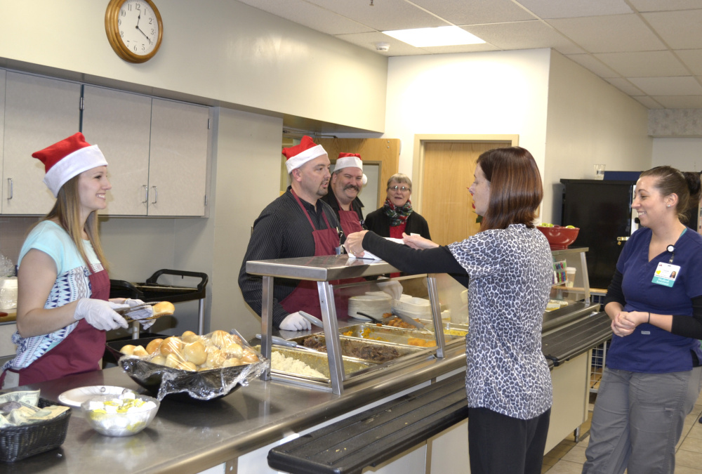 The third annual Meal for a Meal took place on Nov. 30 in the Franklin Memorial Hospital cafeteria in Farmington. Behind the counter, from left, are Katie Drouin, Scott Foster, Greg O'Donal, and Shannon Smith, chamber member.