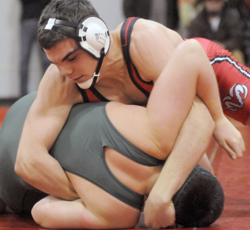 Cony sophomore Nic Mills pins Oxford Hills High School's Isaiah Wright during a match Wednesday night in Augusta.
