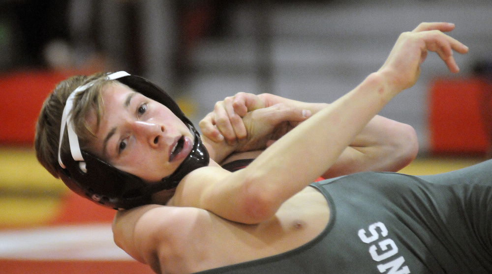 Cony sophomore Noah Dumas grips Oxford Hills wrestler Riley Smith during a match Wednesday night in Augusta.
