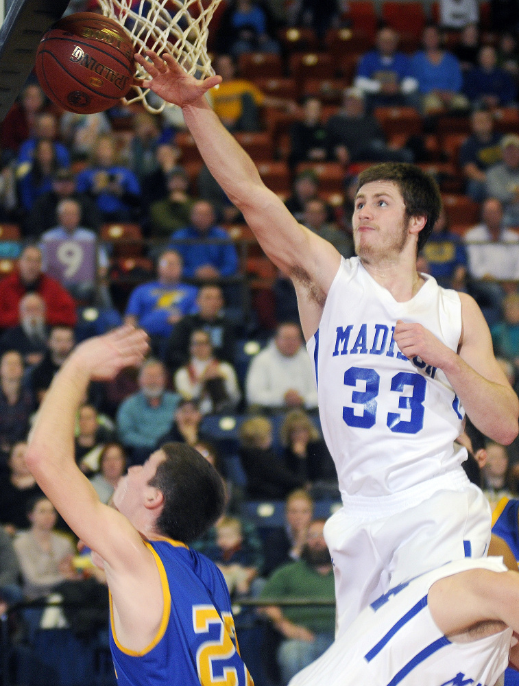 Madison center Mitch Jarvais blocks a shot from Boothbay's Jacob Leonard during a Class C South quarterfinal game last season at the Augusta Civic Center.