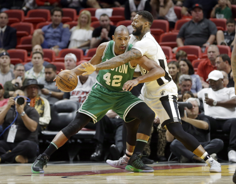 Boston Celtics center Al Horford (42) drives against Miami Heat forward James Johnson (16) in the second half Sunday in Miami. The Celtics won 105-95.