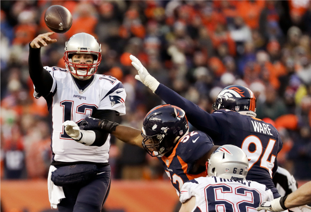 New England Patriots quarterback Tom Brady passes under pressure against the Denver Broncos during the second half Sunday, in Denver.