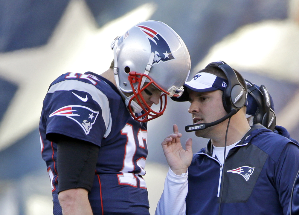 New England Patriots quarterback Tom Brady (12) confers with offensive coordinator Josh McDaniels during the first half of a game against the Los Angeles Rams in Foxborough, Massachusetts.