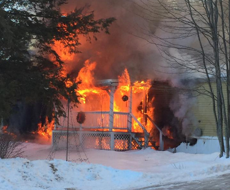 A home burns Tuesday morning at 15 Blue Rock Road in Monmouth.