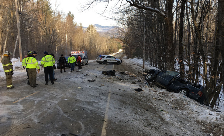 Police and emergency responders work Tuesday morning at the scene of a fatal car crash on Route 145 in Freeman Township.