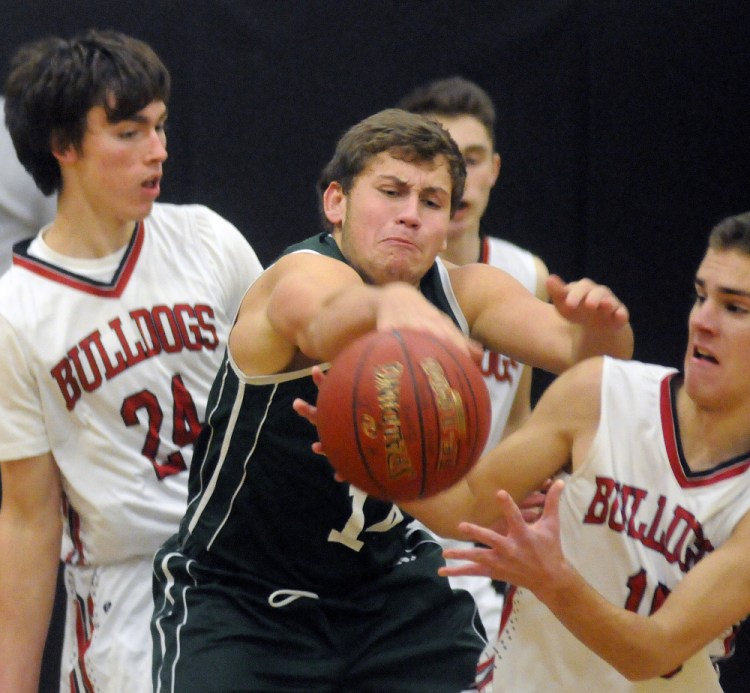 Hall-Dale's Alec Byron, right, and Owen Dupont (24) sandwich Carrabec's Dylan Willette during a Mountain Valley Conference game Tuesday in Farmingdale.