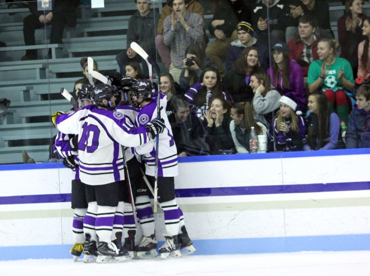 Waterville's Matt Jolicoeur (10) celebrates a Purple Panther goal with teammates and the high school's student section during second-half action against Messalonskee on Thursday at Colby College in Waterville.