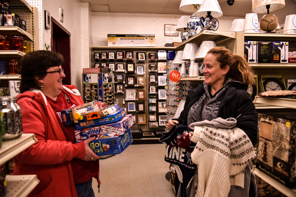 Janet Richards, left, of Pittston, shares a chuckle with fellow shopper Melinda Thibeault, left, of Hallowell Saturday while the two were shopping for last minute gifts at Renys in Gardiner.