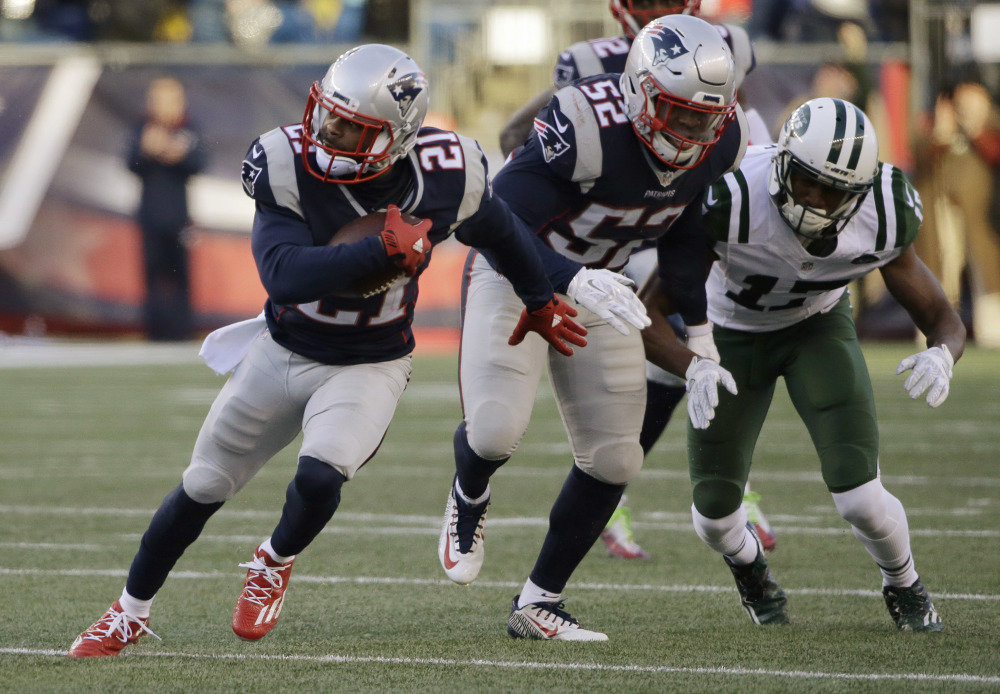 New England Patriots cornerback Malcolm Butler (21) runs with the ball after intercepting a pass intended for New York Jets wide receiver Charone Peake (17) during the second half Saturday in Foxborough, Massachusetts. Butler had two interceptions and a fumble recovery in the game.