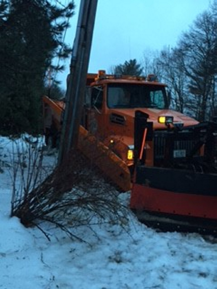 This Waterville Public Works truck was one of three that slid off area roadways while treating with salt and sand Monday night and Tuesday morning.