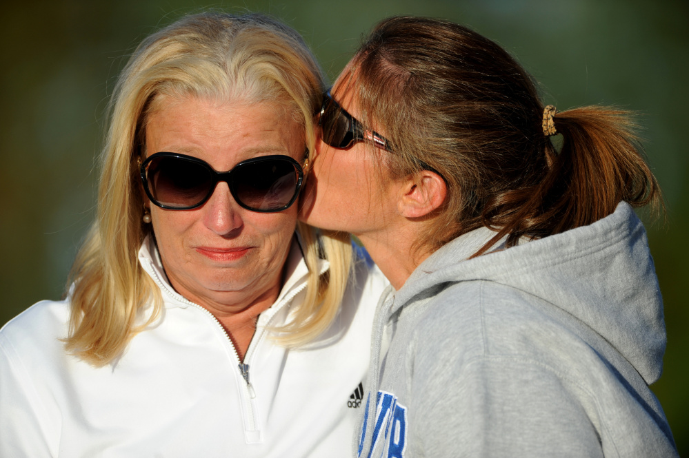 Paula Doughty, left, head coach of the Skowhegan Area High School field hockey team, becomes emotional as she receives a kiss from Brandi Merry after Doughty won her 500th career game, a 15-0 decision over Lewiston this past season in Skowhegan. Merry was a captain on the 1991 state championship team.