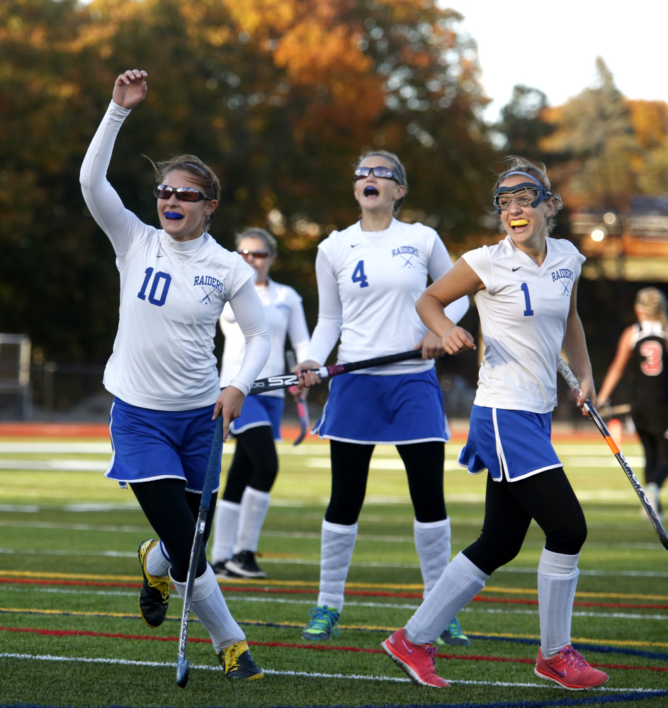 Oak Hill teammates Kylee Veilleux, left, Maegan Sheehy (4) and Erika Hannigan celebrate a goal during the second half of the Class C South championship game last season at Fitzpatrick Stadium in Portland.