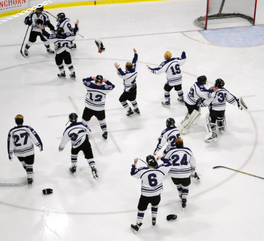 The Waterville hockey team celebrates after it won the Class B state championship last season at Androscoggin Bank Colisse in Lewiston.