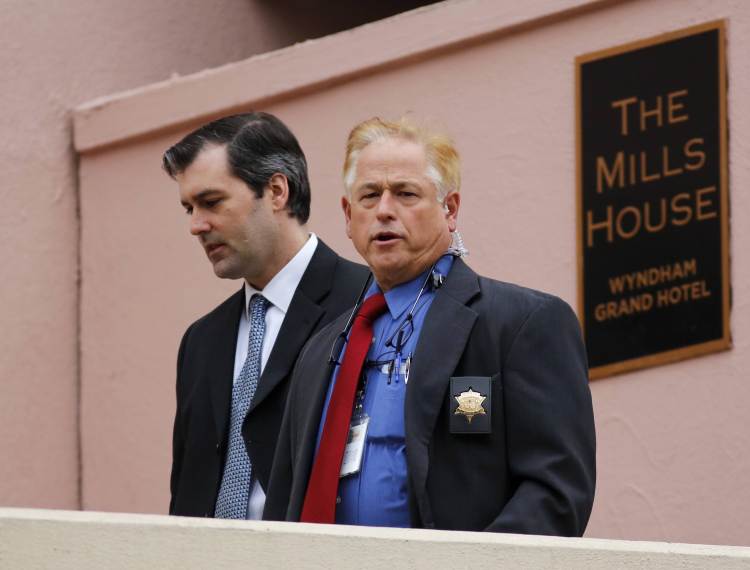 Michael Slager, left, walks from The Mills House Hotel to the Charleston County Courthouse under the protection from the Charleston County Sheriff's Department during a break in the jury deliberations for his trial on Monday.