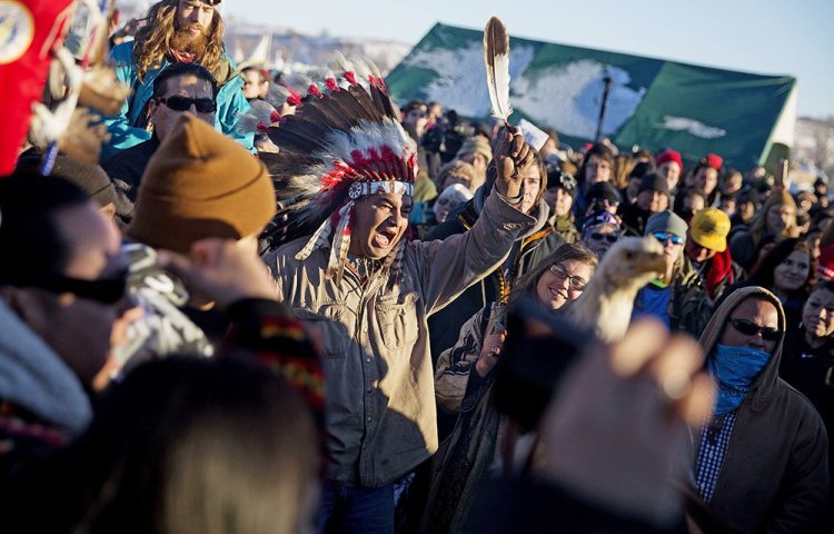 Protesters celebrate at the Oceti Sakowin camp after it was announced that the U.S. Army Corps of Engineers won't grant an easement for the Dakota Access oil pipeline in Cannon Ball, N.D., Sunday. <em>Associated Press/David Goldman</em>