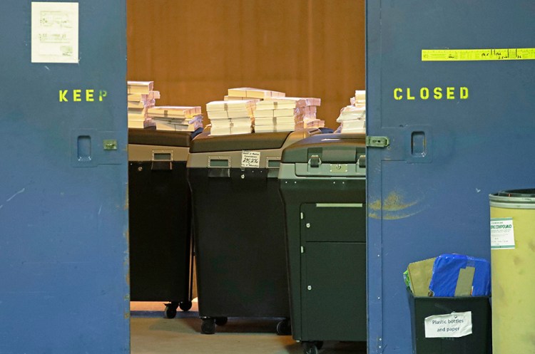 Ballots are stacked up behind a door as a statewide presidential election recount begins Thursday in Milwaukee – the first candidate-driven statewide recount of a presidential election in 16 years. Donald Trump won the state by less than a percentage point over Hillary Clinton after polls long predicted a Clinton victory.  <em>Associated Press/Morry Gash</em>