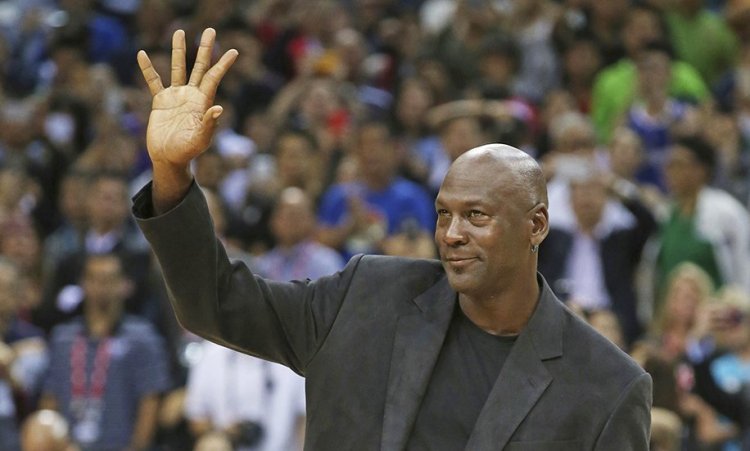 NBA legend Michael Jordan waves to fans at a Charlotte Hornets game in 2015. "Nothing is more important than protecting your own name, and today's decision shows the importance of that principle," Jordan said. in a statement. <em>Associated Press/Kin Cheung</em>