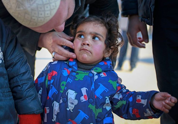 A Syrian child is comforted after she and other members of her family crossed into Turkey at the Cilvegozu border gate with Syria, near Hatay, southeastern Turkey, Sunday. <em>Associated Press/Emrah Gurel</em>