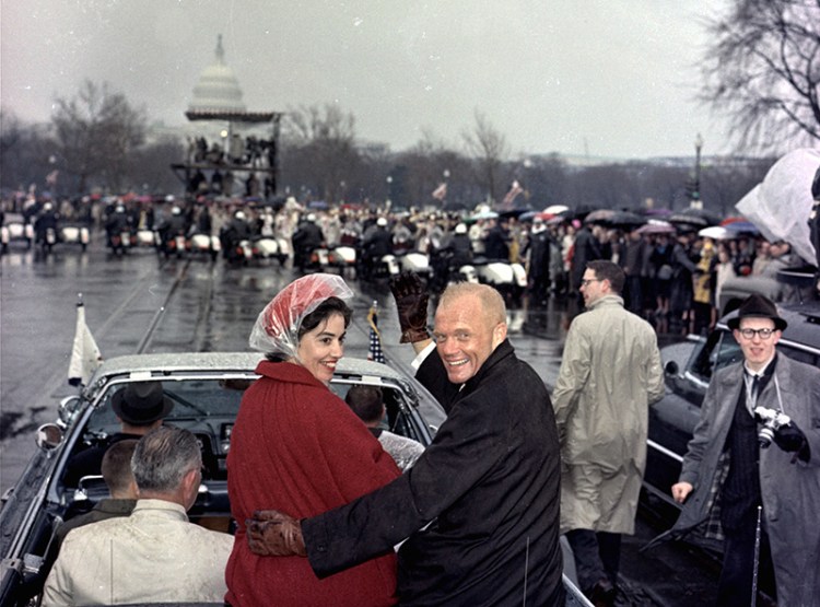 Mercury astronaut John Glenn, and his wife, Annie, ride in the back of an open car with Vice-President Johnson during a parade in Glenn's honor in Washington in February 1962.
