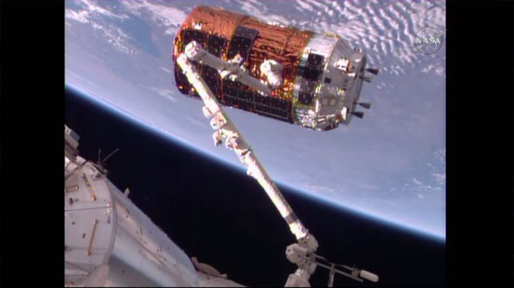 The space station's Canadarm2 snags Japan’s HTV-6 cargo craft in preparation for a resupply delivery on Tuesday morning, Dec. 13, 2016.