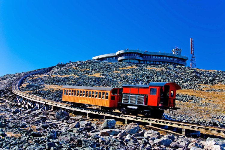 A Mount Washington Cog Railway locomotive pushes a car to the summit of the highest peak in the Northeast. The railway's owner wants to build an upscale hotel about a mile below that the train would pass through on its way to and from the summit. Photo courtesy of Mount Washington Cog Railway