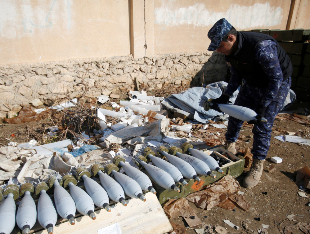 An Iraqi security forces member inspects ammunition Sunday during a battle with Islamic State militants in Mosul.