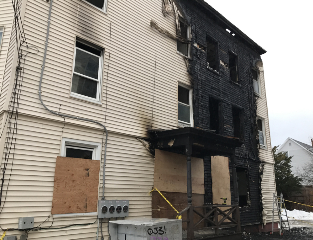 The siding at 6 Cumberland Ave. was blackened by Monday night's fire, which spread to three neighboring buildings and displaced a total of 33 people.