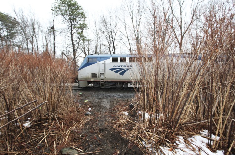 A Downeaster train travels northbound parallel to First Street, near where Carson Filiault accidentally backed over an embankment from his apartment, jumping out of his truck just before it was crushed by a passing Downeaster train.
