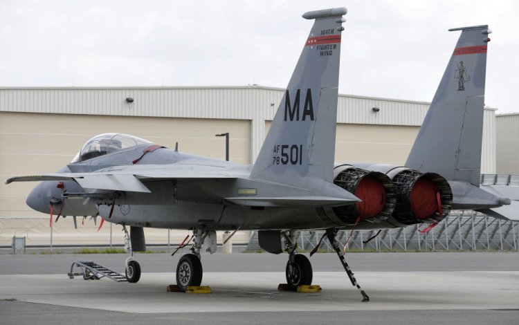 In this Aug. 27, 2014, file photo, a Massachusetts Air National Guard F-15C fighter aircraft sits near a hangar at Barnes Air National Guard Base, in Westfield, Mass. A 14-year-old Air National Guard proposal could be considered in 2017 that would allow the twin-engine fighters from Massachusetts to fly as low as 500 feet along a corridor in western Maine and the northern tip of New Hampshire.