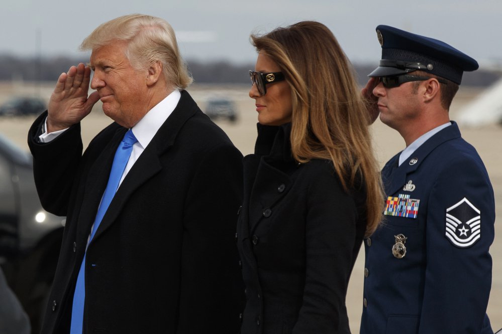 President-elect Donald Trump salutes as he and his wife, Melania, arrive at Andrews Air Force Base, Maryland, on Thursday in preparation for Friday's inauguration.