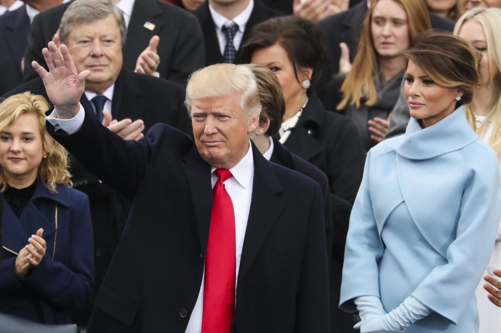 President-elect Donald Trump waves from the podium, with Melania Trump at right, during the 58th Presidential Inauguration at the U.S. Capitol in Washington on Friday.