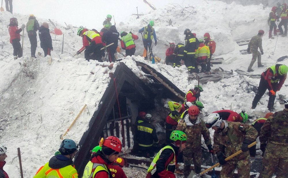 Rescuers work at the site of the avalanche-demolished Rigopiano hotel in central Italy. After two days huddled in freezing cold, with tons of snow surrounding them in the wreckage of the hotel, survivors greeted their rescuers as "angels."