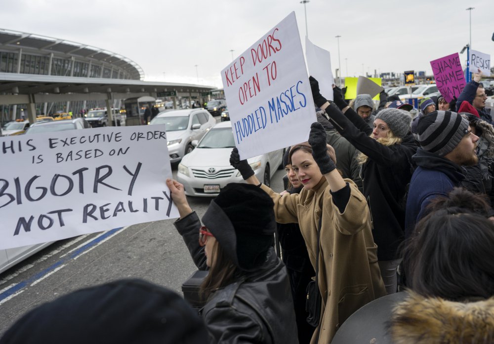 Protesters assemble at John F. Kennedy International Airport in New York, Saturday, Jan. 28, 2017 after two Iraqi refugees were detained while trying to enter the country. On Friday, Jan. 27, President Donald Trump signed an executive order suspending all immigration from several majority-Muslim countries for 90 days.