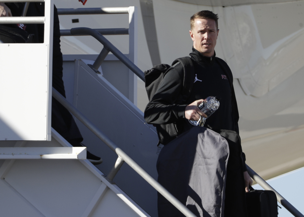 Falcons quarter Matt Ryan leaves the plane after the team arrived at Houston's George Bush Intercontinental Airport Sunday in advance of the Super Bowl.
