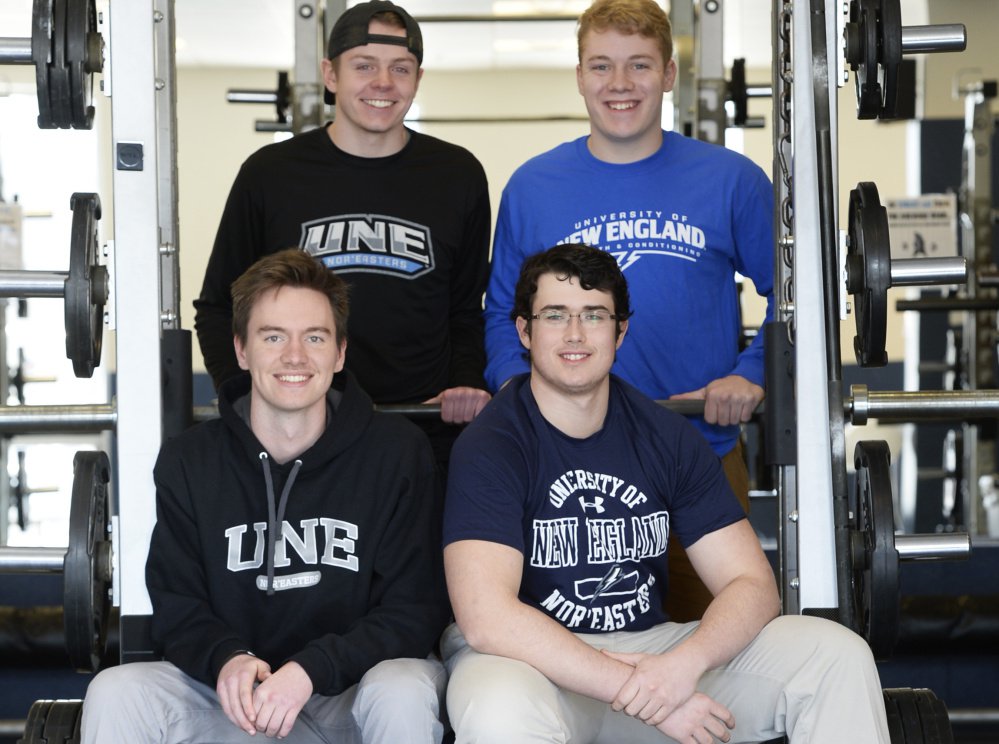 University of New England students Henry Shroder and Eric Ruest (front) and Christian Dunbar and Ryan Phelps (back) are preparing for the debut of their school's football program, which will play a sub-varsity schedule in 2017 and move to varsity status in 2018.