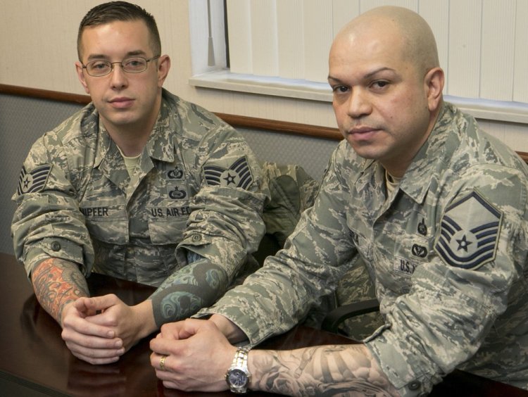 Sgts. Robert Knipfer and Joseph Rivera show their tattoos at Scott Air Force Base in Illinois. A new Air Force policy takes effect Wednesday.