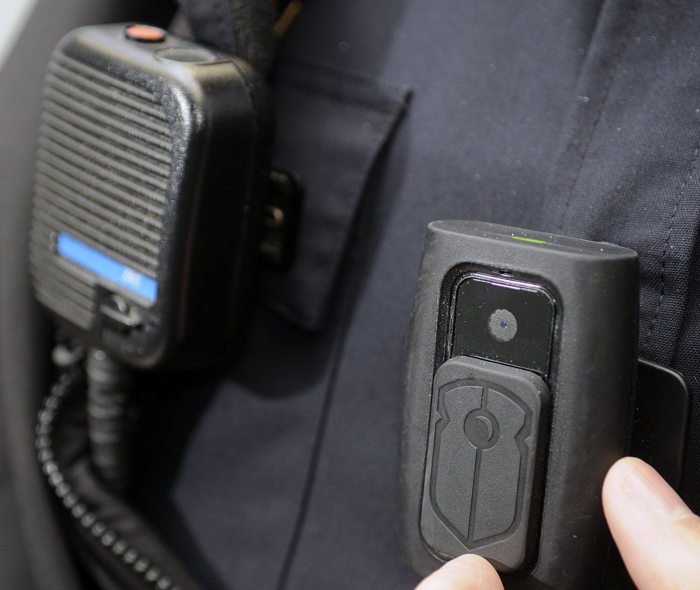 A body camera, right, is attached to the chest of a Gardiner police officer. The camera records video and audio when the officer turns it on.