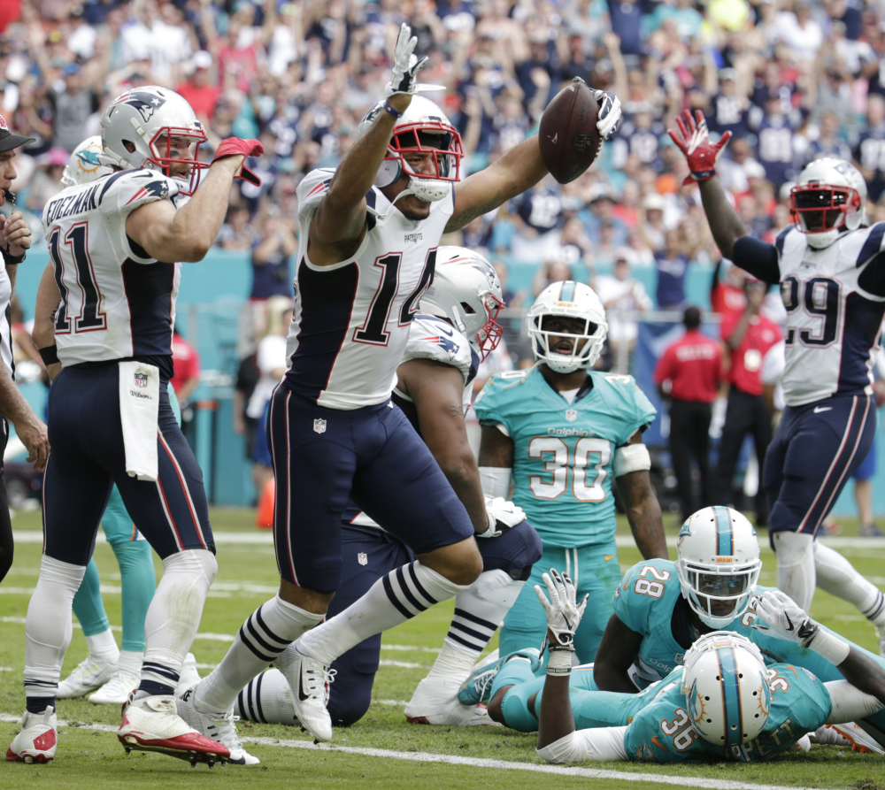 New England Patriots wide receiver Michael Floyd (14) celebrates his touchdown, during the first half against the Miami Dolphins on Sunday in Miami Gardens, Florida.