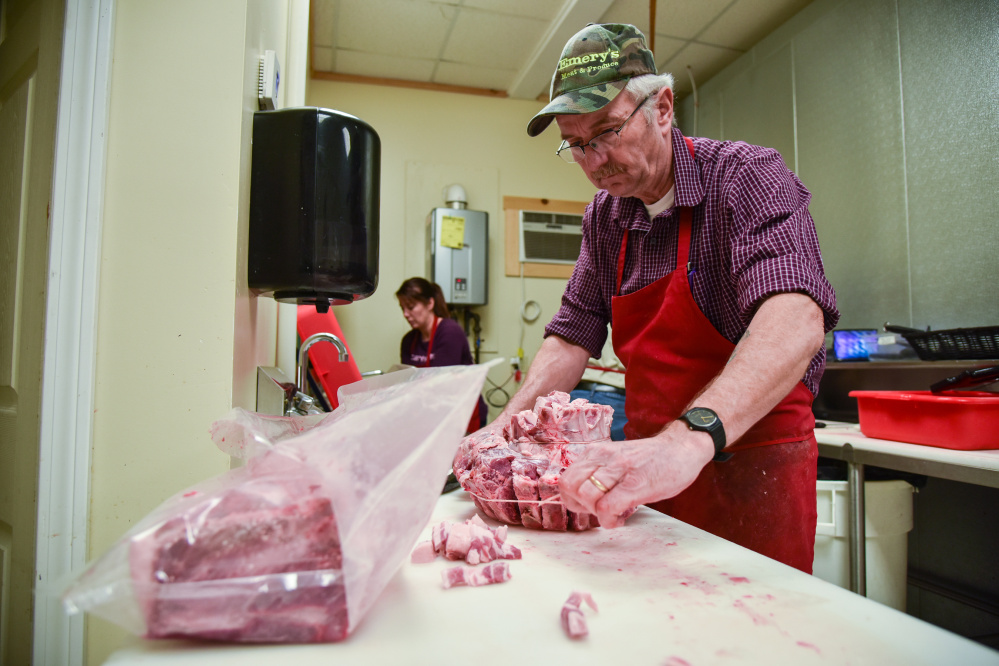 Leon Emery has been cutting meat since he was 12 years old. More than 40 years later he, along with his family, runs Emery's Meat & Produce in Gardiner and Newport. He is shown here preparing a pork loin crown.