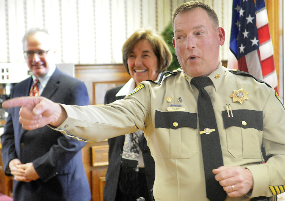 Ken Mason points to friends and relatives after being sworn in  Tuesday as the Sheriff of Kennebec County in Augusta.