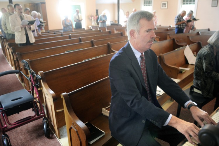 Mark Johnston plays the organ during Sunday service Aug. 28 at the Bunker Hill Baptist Church in Jefferson, where he has played the organ and piano for 50 years.