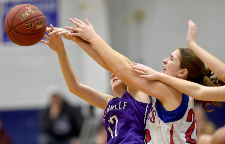 Messalonskee's McKenna Brodeur, right, battles for a rebound with Waterville's Lily Foster (12) on Wednesday in Oakland.
