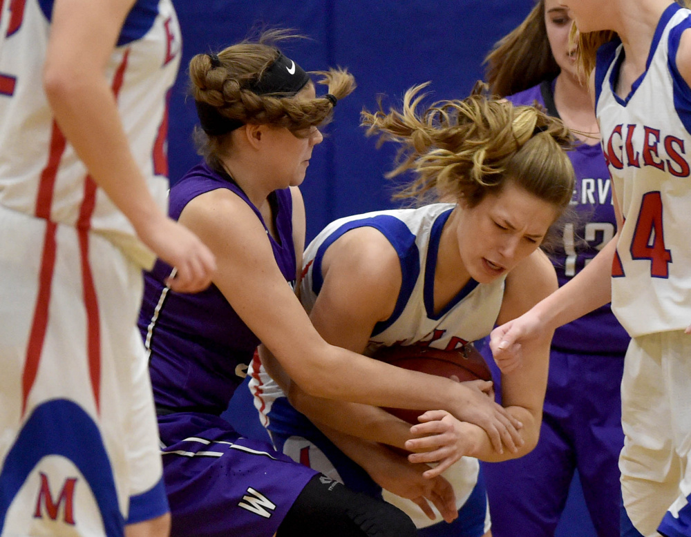 Messalonskee's  Sophie Holmes, center right, battles for a loose ball with Waterville's Maddie Martin, left, Wednesday in Oakland.