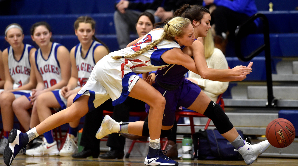 Messalonskee's Ally Turner, left, battles for a loose ball with Waterville's Jordan Jabar on Wednesday in Oakland.